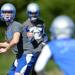 A Lincoln football player looks to pass the ball during practice at the school on Wednesday, August 14, 2013. Melanie Maxwell | AnnArbor.com